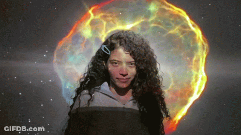 Woman With Curly Hair In Front Of Glowing Object GIF