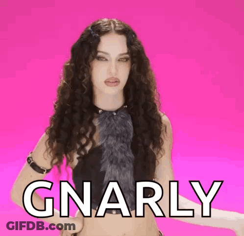 Woman With Curly Hair In Front Of Pink Background With Gnarly GIF