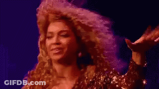 Woman With Curly Hair In Front Of Purple Background Saying Some GIF
