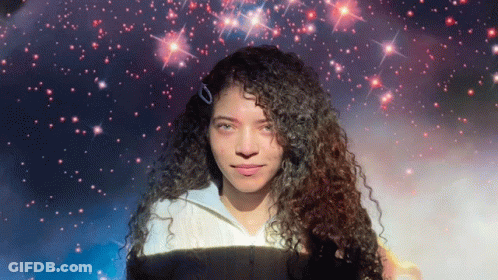 Woman With Curly Hair In Front Of Starry Background GIF