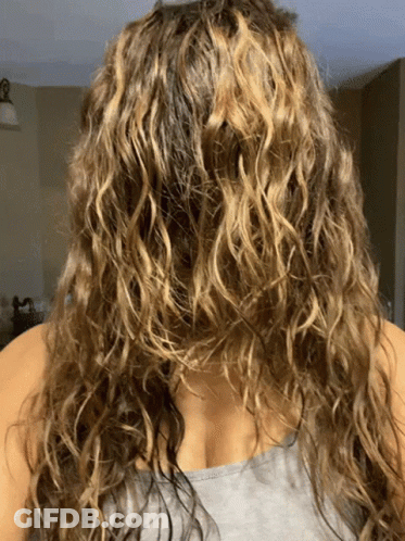 Woman With Curly Hair In Gray Tank Top GIF