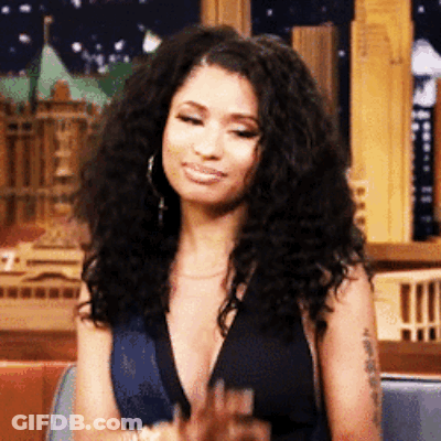 Woman With Curly Hair In Plunging Black Top GIF