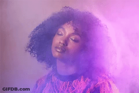 Woman With Curly Hair In Purple Smoke GIF