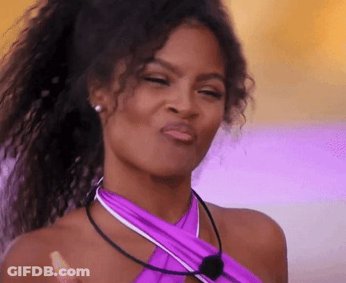 Woman With Curly Hair In Purple Top Making Face GIF