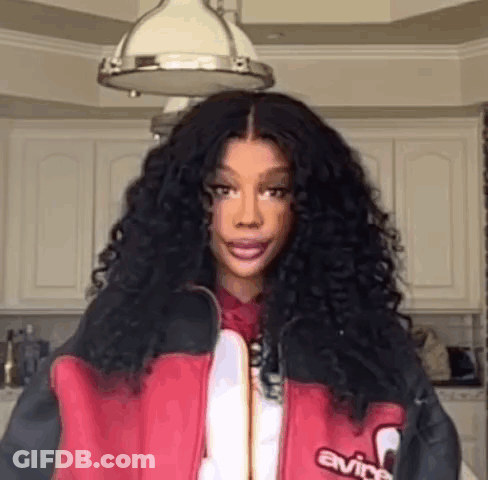 Woman With Curly Hair In Red And Black Jacket GIF
