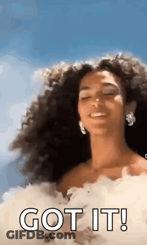 Woman With Curly Hair In White Dress Smiling GIF
