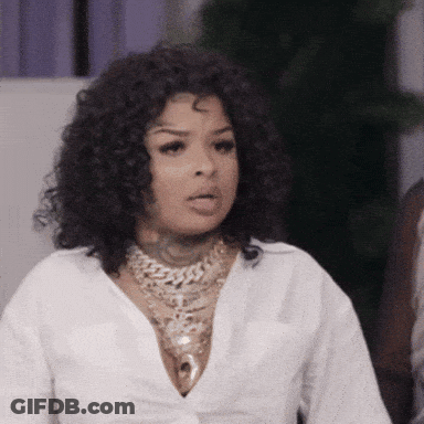 Woman With Curly Hair In White Shirt And Gold Necklace GIF