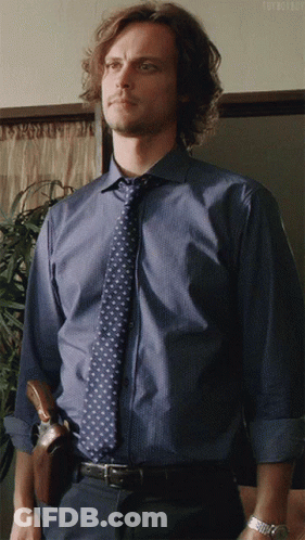 Woman With Curly Hair In Zebra Print Shirt On Couch GIF