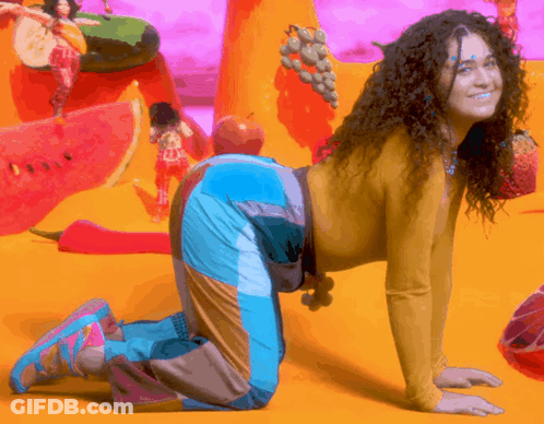 Woman With Curly Hair Kneeling On Floor GIF