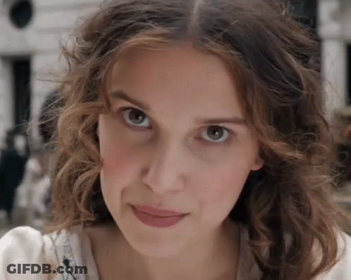 Woman With Curly Hair Looking At Camera GIF