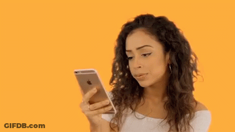 Woman With Curly Hair Looking At Cell Phone GIF