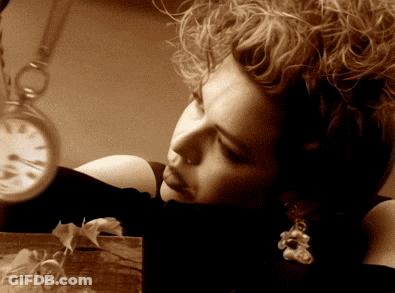 Woman With Curly Hair Looking At Pocket Watch GIF