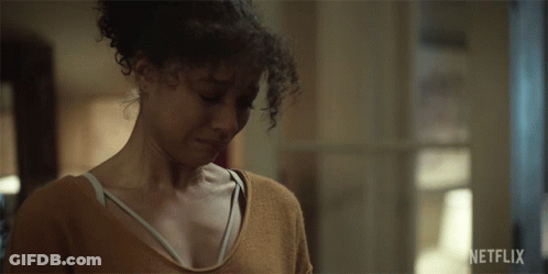 Woman With Curly Hair Looking Down Netflix Ad GIF