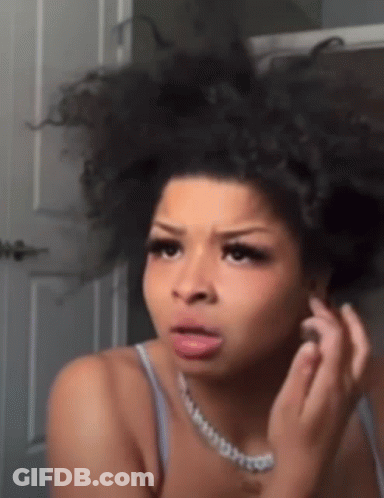 Woman With Curly Hair Looking In Mirror GIF