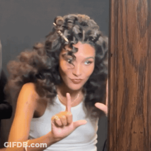 Woman With Curly Hair Making Funny Face GIF