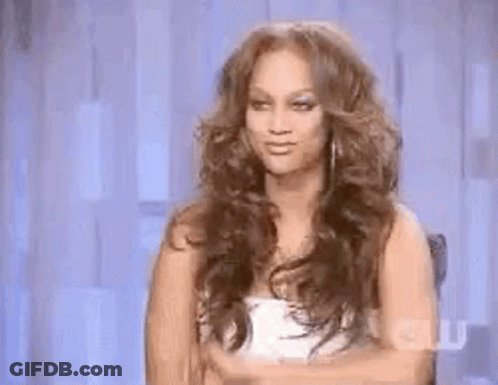 Woman With Curly Hair Making Funny Face In Chair GIF