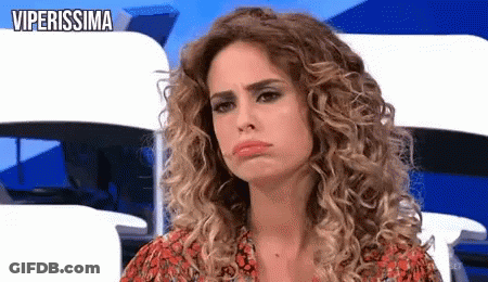 Woman With Curly Hair Making Funny Face In Red Dress GIF