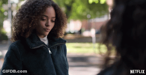 Woman With Curly Hair Next To Another Woman In Netflix Advertisement GIF
