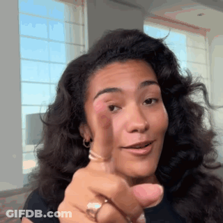 Woman With Curly Hair Pointing At Camera GIF