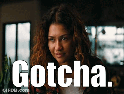 Woman With Curly Hair Saying Gotcha In Front Of Window GIF