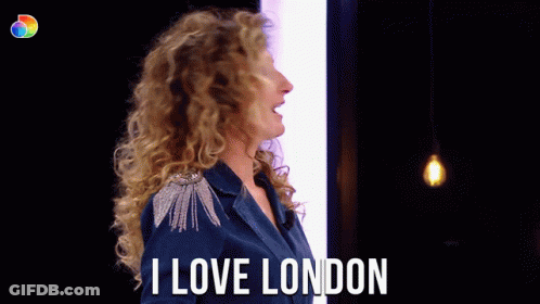 Woman With Curly Hair Says I Love London In Front Of Light Bulb GIF