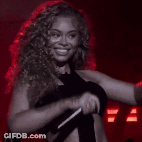 Woman With Curly Hair Smiling And Flexing GIF