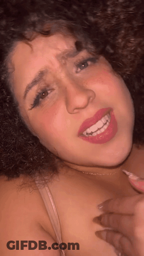 Woman With Curly Hair Smiling And Making Face GIF