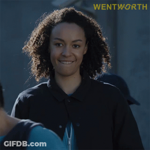 Woman With Curly Hair Smiling At Wentworth Sign GIF