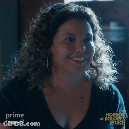 Woman With Curly Hair Smiling In Front Of Prime Sign GIF