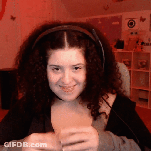 Woman With Curly Hair Smiling In Headphones GIF