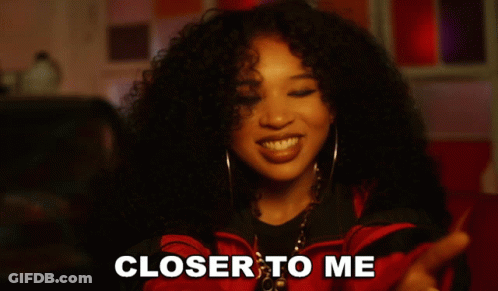 Woman With Curly Hair Smiling With Words Closer To Me GIF