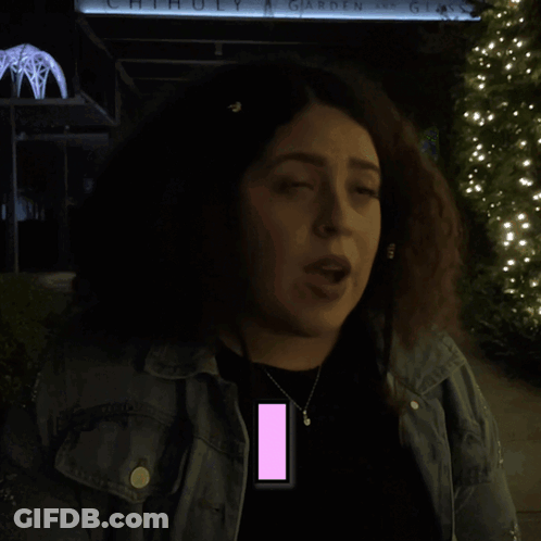 Woman With Curly Hair Standing In Front Of Recognize Sign GIF