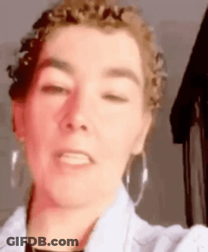 Woman With Curly Hair Taking Selfie GIF