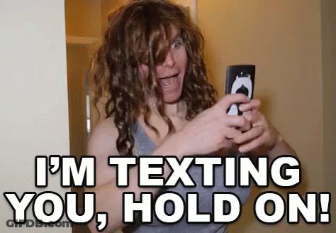Woman With Curly Hair Taking Selfie Saying I'm Texting You Hold On GIF
