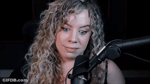 Woman With Curly Hair Talking Into Microphone GIF