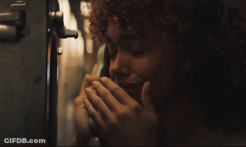Woman With Curly Hair Talking On Phone GIF