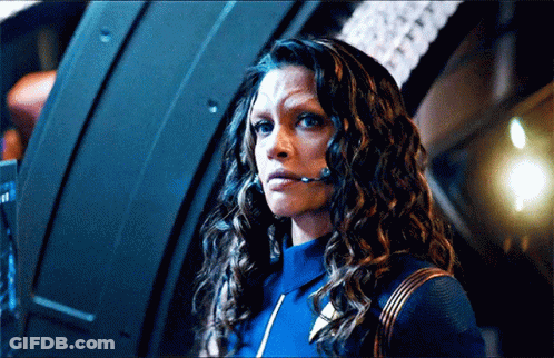 Woman With Curly Hair Wearing Headset In Dark Room GIF