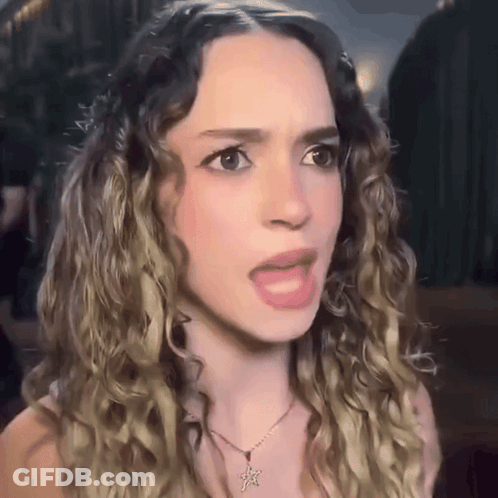 Woman With Curly Hair Wearing Necklace With Star GIF