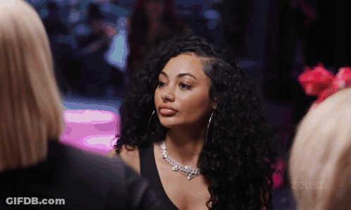 Woman With Curly Hair Wearing Zeus Necklace GIF