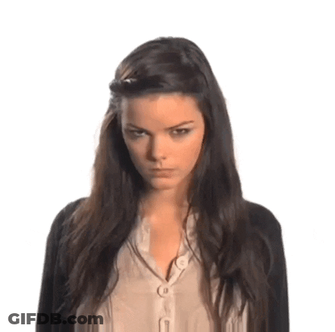 Woman With Dark Hair, Black Cardigan, Beige Shirt GIF