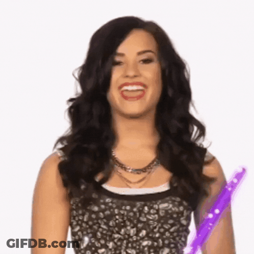 Woman With Dark Hair Holding Purple Wand GIF