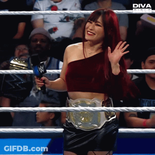 Woman With Diva Belt In Wrestling Ring Holding Microphone GIF