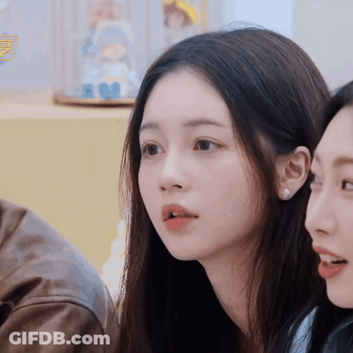 Woman With Doll In Display Case GIF