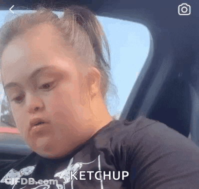 Woman With Down Syndrome Sitting In Car With Ketchup On Face GIF