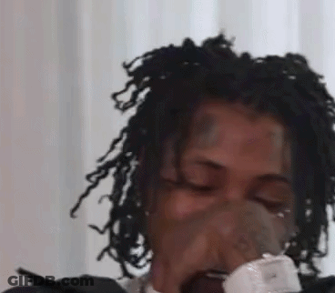 Woman With Dreadlocks Blowing Nose Into Tissue GIF