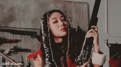 Woman With Dreadlocks Holding Gun GIF
