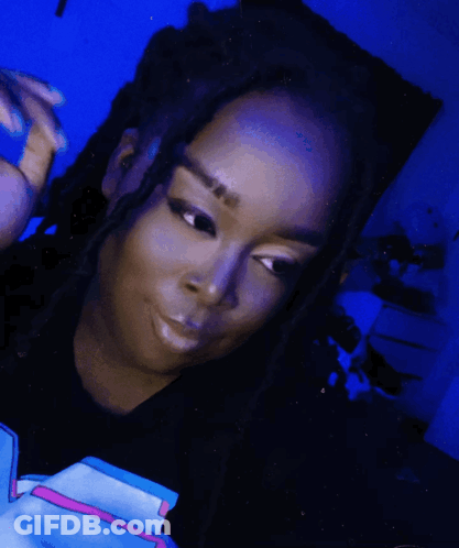 Woman With Dreadlocks In Black Shirt With Pink Stripe GIF
