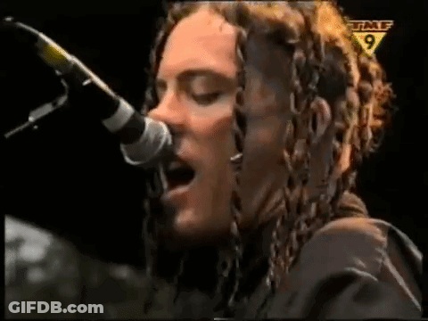 Woman With Dreadlocks Singing Into Microphone GIF