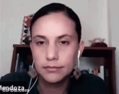 Woman With Ear Buds Looking At Camera GIF