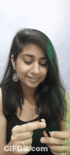 Woman With Earrings And Ring Holding Something GIF